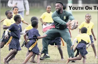  ?? PICTURE: LEON LESTRADE ?? Springbok flank, Siya Kolisi, shows some youngsters how it’s done during a coaching clinic held at College Rovers in Durban, yesterday. South Africa face France in their second Test match at King’s Park on Saturday.