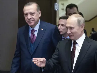  ??  ?? Russia’s President Vladimir Putin shows the way to Turkey’s President Tayyip Erdogan during a meeting on Monday in Sochi, Russia. (Reuters)