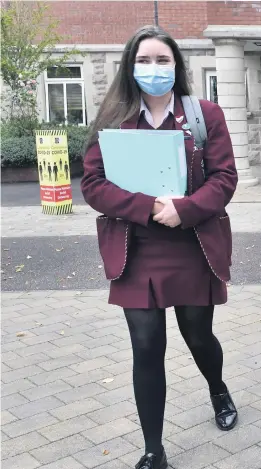  ?? PACEMAKER ?? Back to class: Pupils from St Dominic’s in Belfast return to school in September wearing masks; Peter Weir addresses the Assembly yesterday (top), and (below) locked gates at Lagmore Primary in Lisburn