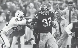  ?? HARRY CABLUCK — THE ASSOCIATED PRESS FILE ?? Pittsburgh’s Franco Harris, right, eludes Oakland’s Jimmy Warren as he runs for the game-winning touchdown after catching a deflected pass during an AFC Divisional playoff game in Pittsburgh on Dec. 23, 1972.