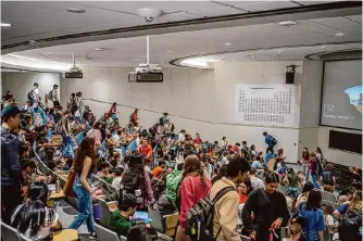  ?? Getty Images file photo ?? Students await a lecture at the University of Texas at Austin, which recently laid off dozens of employees to comply with a new state ban on diversity, equity and inclusion programs.