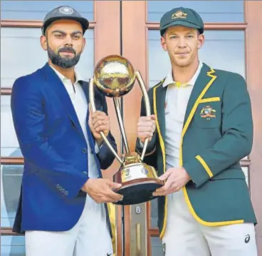  ?? AFP ?? Australia captain Tim Paine (right) and India skipper Virat Kohli pose with the Border-gavaskar Trophy ahead of the first Test starting at the Adelaide Oval from Thursday. India have won only one of their 11 Tests at this venue.