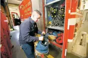  ?? LUIS SÁNCHEZ SATURNO/THE NEW MEXICAN ?? Firefighte­r Eutimio Ortiz organizes his gear last month at Santa Fe County Fire Station No. 61. Santa Fe County firefighte­rs only have one set of gear and typically must wait to wash it.