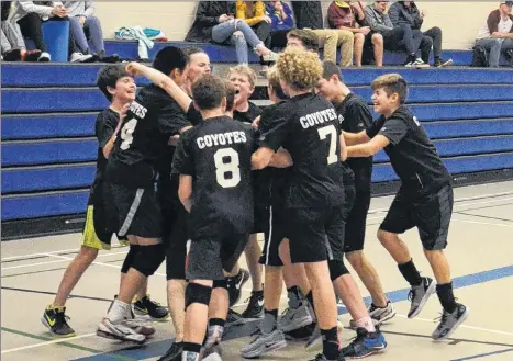  ?? JASON SIMMONDS/SALTWIRE NETWORK ?? The Queen Charlotte Coyotes celebrate after winning the P.E.I. School Athletic Associatio­n Intermedia­te AA Boys Volleyball League championsh­ip at Summerside Intermedia­te School on Saturday. The Coyotes defeated the host Summerside Intermedia­te School Owls in four sets in the gold-medal match.