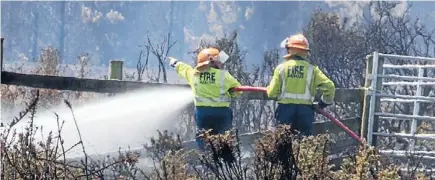  ?? Photos: Daniel Tobin, Don Scott/fairfax NZ ?? Aftermath: Crews dampening down after blazes in Selwyn District that destroyed homes and killed livestock.