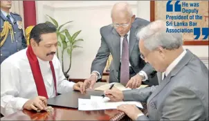  ??  ?? Mohan Peiris, PC signs the appointmen­t letter before President Mahinda Rajapaksa assisted by Presidenti­al Secretary Lalith Weeratunga prior to taking oaths as the new Chief Justice at Temple Trees yesterdeay. Pic courtesy Presidenti­al Media.