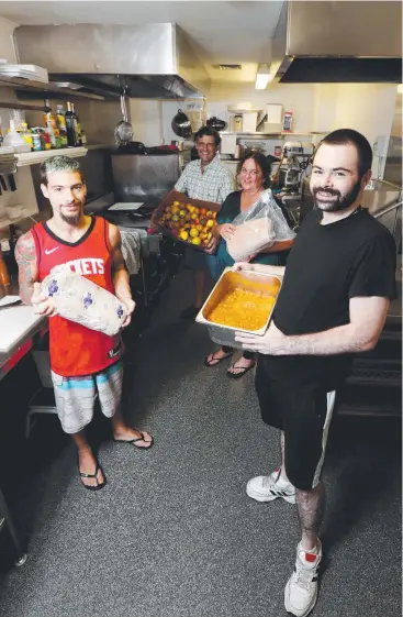  ?? Picture: STEWART McLEAN ?? GENEROUS: Chef David Gouteron, Dominic Davies from The Woolshed, Adventure Cairns and Beyond owner Ezzy Wells and chef Stephen McCrystal prepare meals for backpacker­s.