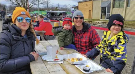  ?? Bill Atwood ?? Rural Roots Brewing Company in Elmira held a “Sapfest” on Apr. 2 to celebrate this year’s Maple Weekend. The all-day event filled with family fun games, live bands and food was a joint effort between the Elmira Maple Syrup Festival and the brewery. (Top) Sarah, Luke, Marc and Knox Lareau having some family time and food.