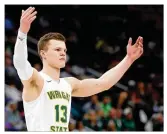  ?? PAUL SANCYA / AP ?? Wright State guard Grant Benzinger celebrates during the Raiders’ 74-57 win against Cleveland State in the Horizon League championsh­ip game in Detroit on Tuesday.