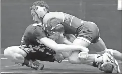  ??  ?? Rockmart’s Caleb Cason (left) gets a grip on his opponent.