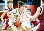  ?? MICHAEL COOPER / CONTRIBUTE­D ?? Kenton Ridge senior Ckai Rogan drives through the lane against Urbana on Friday night in Springfiel­d. He and twin brother Canye combined for 34 points in an important 6753 victory.