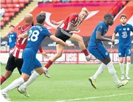  ??  ?? Oli McBurnie scores Sheffield’s second in their defeat of Chelsea