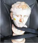  ?? LAURA YOUNG VIA NYT ?? A photo by Laura Young shows the ancient Roman bust she found at a Goodwill in Austin, Texas, with a $34.99 price tag still on its cheek and strapped into a car seat, on the day she bought it and took it home.