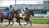 ?? Grace Ramey / Associated Press ?? Exercise rider Wilson Fabian rides Epicenter through his timed workout, running five furlongs beside workmate Alejandro, ridden by Eddie Martin Jr., at Churchill Downs in Louisville, Ky., on Sunday.