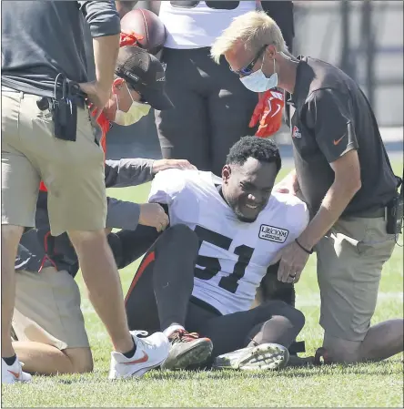  ?? JOHN KUNTZ —THE ASSOCIATED PRESS ?? Mack Wilson is helped up by the team’s medical staff after suffering a knee injury in a 7-on-7drill during training camp Aug. 18in Berea.