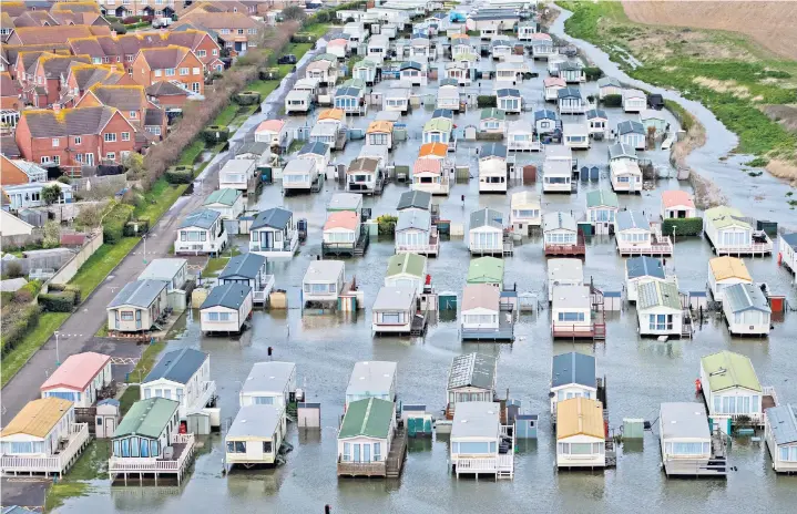  ?? ?? Flooded caravan park near Braclesham, West Sussex, main; Severe flooding in Littlehamp­ton, far left, where emergency services rescued stranded residents, left; Beach huts at Falmouth, Cornwall are washed out to sea, right