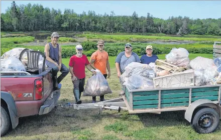  ?? ERIC MCCARTHY/JOURNAL PIONEER ?? Milton Chaisson, from left, Thane Doucette, Daniel Gavin, Danny Murphy and Jock Rix display the garbage seven workers from two watersheds groups and two volunteers gathered from 40 kilometers of beaches and streams from Waterford to Burton recently.