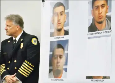  ?? RECORDER PHOTO COURTESY OR RICK ELKINS ?? Tulare County Fire Chief Charlie Norman stands next to poster board with the photos of the arson suspects accused to starting the Pier Fire in August.