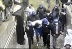  ?? Tulsa World via AP photo ?? Tulsa trainers and players help safety Kendarin Ray to the locker room after a postgame fight following Mississipp­i State’s win in the Armed Forces Bowl on Thursday. Coach Greg Montgomery said Ray was treated for “some sort of concussion.”