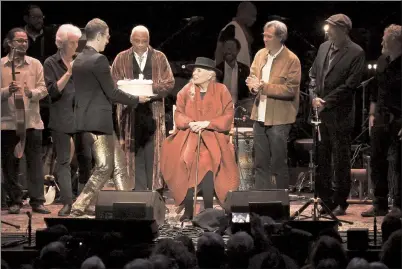  ?? PHOTO BY RICHARD SHOTWELL/INVISION/AP ?? Joni Mitchell is presented with a birthday cake on stage at JONI 75: A Birthday Celebratio­n on Wednesday at the Dorothy Chandler Pavilion in Los Angeles.