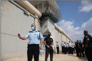  ?? (AP/Sebastian Scheiner) ?? Police officers and prison guards inspect the scene of a prison escape outside the Gilboa prison Monday in northern Israel.