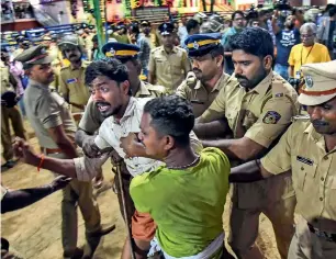  ?? PTI ?? Police detain devotees who were staging a protest against police restrictio­ns at Sannidhana­m in Sabarimala on Sunday night. —