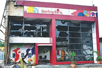  ??  ?? Sterling Bank and Diamond Bank at Creek Road, Apapa, Lagos burnt by protesters, over the killing of a tanker driver …yesterday.