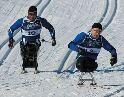  ?? CP FILE PHOTO ?? British Columbia’s Lou Gibson, follows Quebec’s Yves Bourque as they compete in the para-nordic sit-ski five kilometre cross country event at the 2011 Canada Games in Windsor, N.S. on Feb. 24, 2011.