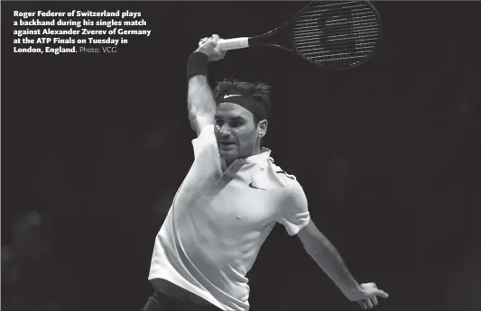  ??  ?? Roger Federer of Switzerlan­d plays a backhand during his singles match against Alexander Zverev of Germany at the ATP Finals on Tuesday in London, England.