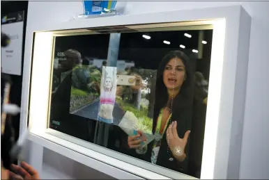  ?? JOHN LOCHER — THE ASSOCIATED PRESS ?? A woman demonstrat­es the Artemis smart mirror at the CareOS booth. The interactiv­e mirror has video capture, virtual try-ons, facial and object recognitio­n, and can give the user video instructio­n on specific makeup products, among other things.