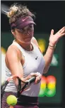  ?? Noel Celis / AFP via Getty Images ?? Elina Svitolina hits a return against Belinda Bencic during the WTA Finals tournament on Saturday.