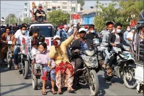  ??  ?? Anti-coup protesters hold a rally Saturday in Mandalay, Burma. More photos at arkansason­line. com/214burma/. (AP)