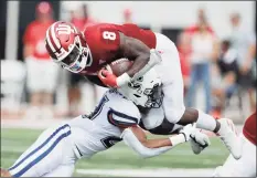  ?? Darron Cummings / Associated Press ?? Indiana running back Stevie Scott III (8) is tackled by UConn linebacker Omar Fortt (27) during a 2019 game.