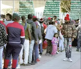  ?? Alejandro Tamayo San Diego Union-Tribune ?? ASYLUM seekers at the border in Tijuana. The reinstated Biden policy is intended to discourage Central Americans from making the perilous journey north.