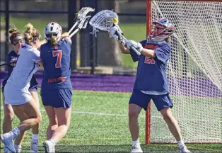  ?? Lori Van Buren / Times Union ?? University at Albany’s Madison Conway tries to score against Syracuse goalie and Niskayuna native Asa Goldstock. Goldstock had two saves in the first half.