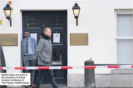  ??  ?? Bullet holes are seen in the windows of Saudi Arabia’s embassy in The Hague, Netherland­s