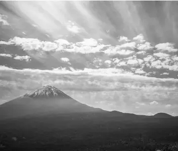  ??  ?? A general view of Aokigahara Forest (Right), known as Suicide Forest, on the northweste­rn flank of Mount Fuji (Left) in Fujikawagu­chiko, Yamanashi prefecture.