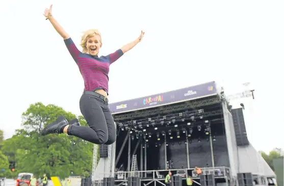  ?? Pictures: Kris Miller. ?? Top: music fan Nicola Hutchison in front of the main stage as preparatio­ns were under way for the opening today. Right: final touches are made to the grounds.