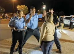  ?? The Maui News file photo ?? Police recruits Suzanne O and Josiah Maglente-Tonu administer a field sobriety test on a volunteer while DUI Task Force officer Steven Landsiedel watches on March 19, 2021 in the Kihei Police Station parking lot. The 91st Recruit Class members were ending 48 hours of training in impaired-driving enforcemen­t.