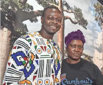  ?? HANNAH MATTIX/CLARION LEDGER ?? Joseph Sambou stands next to his mother and kitchen manager, Sally Demba, at his restaurant, Sambou’s African Kitchen in Jackson, Mississipp­i, on Feb. 28. Many West African restaurant­s are opening across the Southern United States, introducin­g new and exciting flavors to the region.