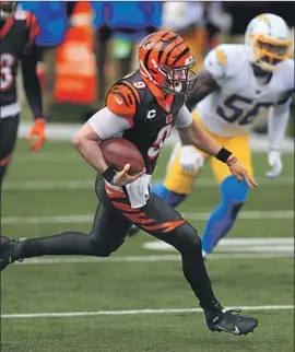  ?? Aaron Doster Associated Press ?? JOE BURROW, running for his first touchdown and the Bengals’ first of the year, didn’t look like a rookie. He prepared for the NFL with an elite quarterbac­k guru.
