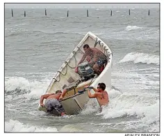  ?? AP/ALEX BRANDON ?? Fishermen launch their boat (left) in rough waves Thursday to try to recover their haul-seine net at Virginia Beach, Va., as Hurricane Florence’s leading edge batters the coastline. At right, police officers block the road leading to Emerald Isle, N.C.