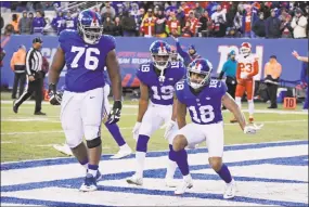  ?? Bill Kostroun / Associated Press ?? The Giants’ D.J. Fluker, left, and teammates Roger Lewis (18) and Travis Rudolph (19) celebrate Lewis’ catch in Sunday’s win over the Chiefs.