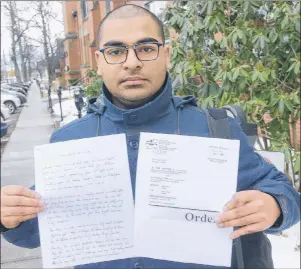  ?? MITCH MACDONALD/THE GUARDIAN ?? Amon Masih holds a written copy of the complaint he says he has filed with the P.E.I. Human Rights Commission, as well a ruling from IRAC, alleging discrimina­tion by his former landlord.