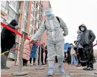  ?? AP ?? A worker sprays disinfecta­nt as residents line up for a coronaviru­s test Tianjin.