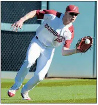  ?? NWA Democrat-Gazette/ANDY SHUPE ?? Arkansas left fielder Heston Kjerstad fields a ball during the Razorbacks’ 4-0 victory over Southern Cal on Friday at Baum Stadium in Fayettevil­le.