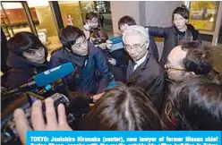  ??  ?? TOKYO: Junichiro Hironaka (center), new lawyer of former Nissan chief Carlos Ghosn, speaks with the media outside his office building in Tokyo yesterday. —AFP