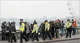  ?? MATT DUNHAM/AP ?? Police officers patrol Friday on Westminste­r Bridge in London where Wednesday’s deadly attack occurred. It was the deadliest in Britain since suicide bombers killed 52 in 2005.