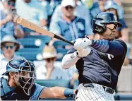  ?? Julio Aguilar/Getty Images ?? The Yankees’ Juan Soto hits a single against the Rays during a spring training game.