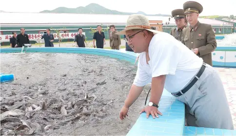  ??  ?? Kim (right) inspecting the Samchon Catfish Farm in South Hwanghae Province. — AFP photo